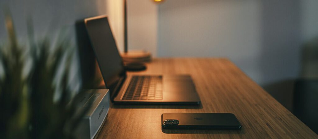 black laptop computer on brown wooden table
